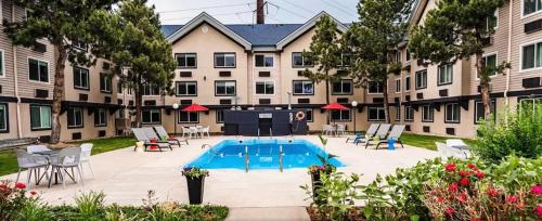 a courtyard with a pool and chairs and a building at Comfort Inn & Suites Golden - Denver West in Golden
