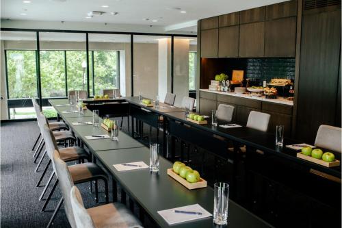 a restaurant with long tables and chairs and a bar at The Study at Johns Hopkins in Baltimore