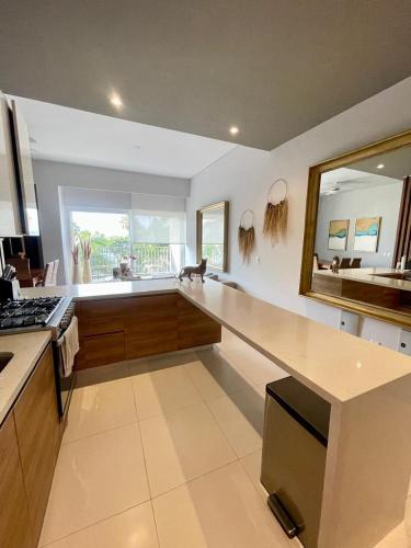a kitchen with a counter and a large mirror at New 2 bedroom rooftop condo in Nuevo Vallarta