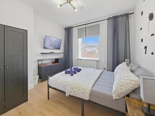 a bedroom with a bed and a window at Urban retreat near the station in London