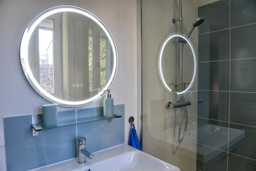 a bathroom with a sink and a mirror at Fleur des Vents in Saint-Flour