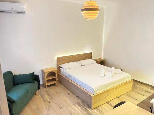 a small bedroom with a bed and a couch at casa vacanza La Palma Rossa Taranto in Taranto