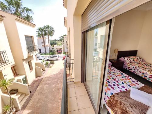 a balcony of a apartment with a bed at RodaGolf Resort Nice Views in San Javier