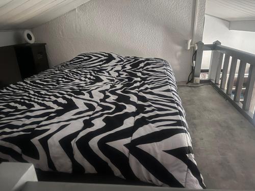 a black and white zebra print bed in a bedroom at Biscalove in Biscarrosse