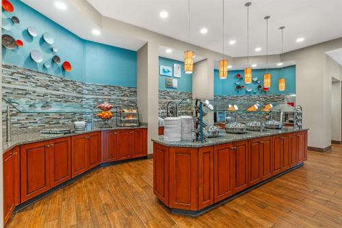 a restaurant with wooden counters and blue walls at Drury Inn & Suites Fort Myers Airport FGCU in Fort Myers
