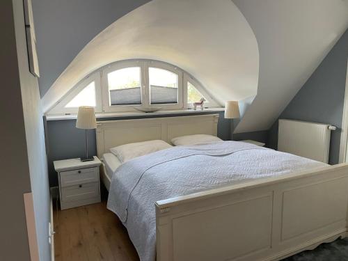 a bedroom with a bed with a window above it at Cora in Pruchten