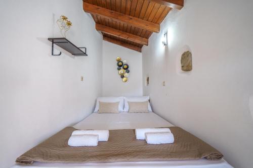 a bedroom with two beds in a attic at Villa Koomas-Mountain View - kakodiki Paleochora in Avdhoulianá