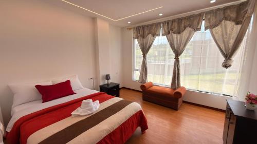a bedroom with a bed and a large window at Casa moderna, amplia y acogedora Valentina in Loja