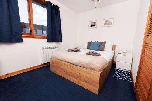 a bedroom with a bed and a window at Sound House, Shetland Islands in Lerwick