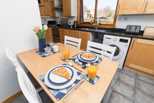 a table with a plate of food on it in a kitchen at Sound House, Shetland Islands in Lerwick