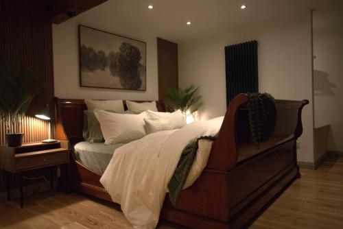 a bedroom with a large bed with white pillows at Stone & Sage- City Centre Luxury Courtyard Lofts in Lancaster