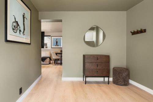 a living room with a dresser and a mirror at Trolltunga Fjords in Tokheim