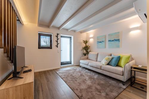 a living room with a couch and a tv at Douro View Charming Apartment Duplex in Valbom