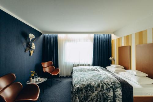 a hotel room with a bed and a window at Hotel Scholz in Aalen