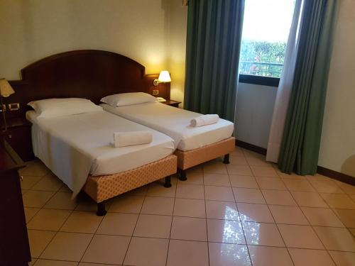 a hotel room with a bed and a window at venice blu hotel in Mirano
