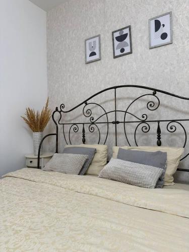 a bed with two pillows on it in a bedroom at Comfort Forum House in Lviv
