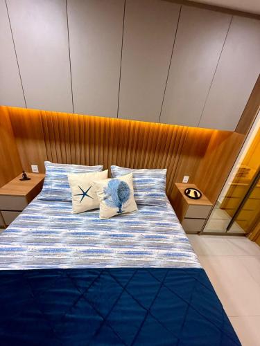 a bedroom with a bed with two pillows at Studio Desing 3 - Lions Maceió in Maceió