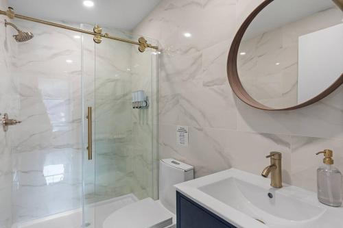 a bathroom with a shower and a sink and a mirror at Spacious w/ 2BR 2Bath - Big Bear in Big Bear City
