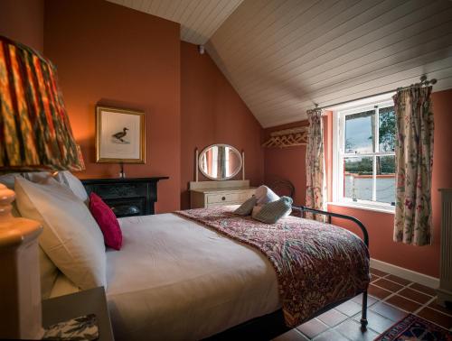 a bedroom with a bed and a window at Killee Cottage in Mitchelstown