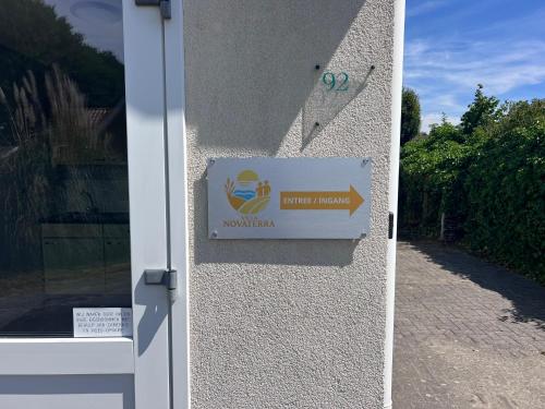 a door with a sign on the side of a building at Villa NovaTerra - Zeewolde in Zeewolde