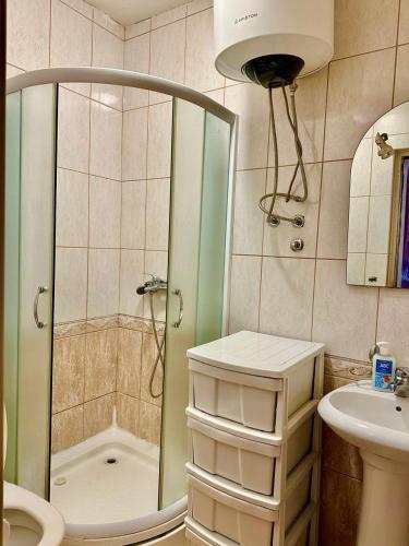 a bathroom with a shower and a sink at ApartMonte in Budva