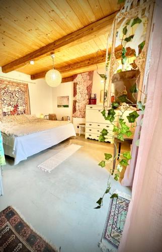a bedroom with a bed and a plant at Bohemian accommodation in a magical idyll! in Simrishamn