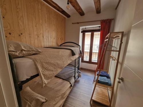 a bedroom with a bed and a mirror and a window at Centrally located two bedroom apartment in Perelló