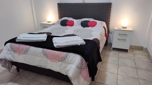 a bedroom with a bed with towels on it at Departamento La Merced in Santiago del Estero