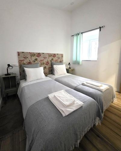 two beds sitting next to each other in a bedroom at Casinhas da Ajuda nº13 in Lisbon