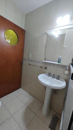 a bathroom with a sink and a mirror at Departamento La Merced in Santiago del Estero