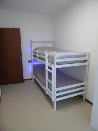 a white bunk bed in a small room at Casa Marta - tra vigne e motori in Castelvetro di Modena