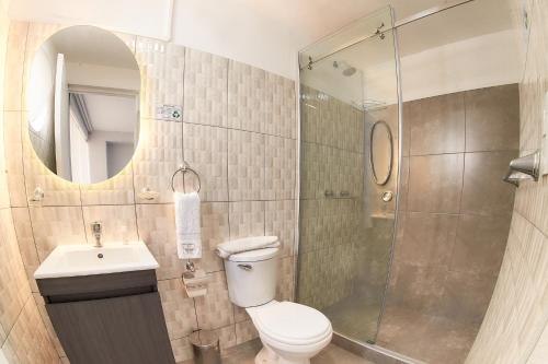 a bathroom with a toilet and a sink and a shower at Hotel Terrazas del sol in Arequipa