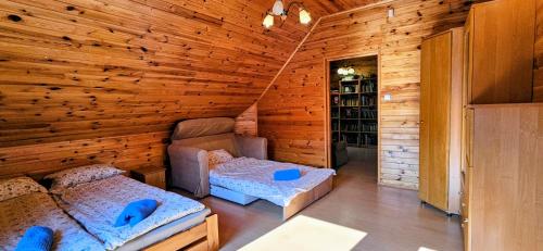 a log cabin with two beds in a room at Chata Górska Sowa, Cały Dom tylko dla Was in Podgórzyn