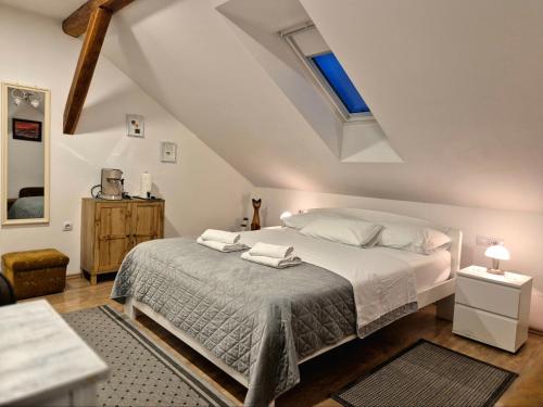 a bedroom with a bed in a attic at Rooms Garden in Slunj