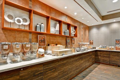 a restaurant with a counter with plates and glasses at SpringHill Suites Denver at Anschutz Medical Campus in Aurora