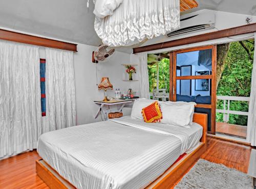a bedroom with a bed and a window at Green Peak Resorts in Baitarāni