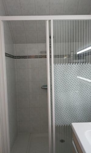 a shower with a glass door in a bathroom at Bed and Breakfast au calme in Avoise