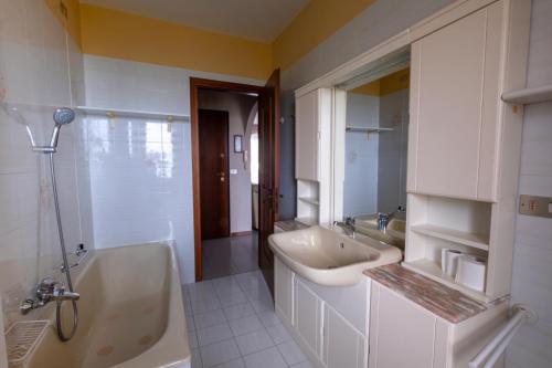 a bathroom with a tub and a sink and a bath tub at Casa Turistica Andora in Marina di Andora