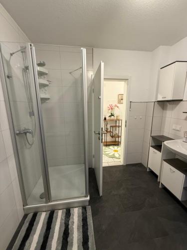 a bathroom with a shower with a glass door at Gaststätte Seehaus Maroth in Maroth
