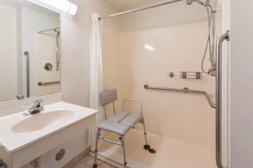 a bathroom with a sink and a shower at GrandStay Hotel & Suites Hastings in Hastings