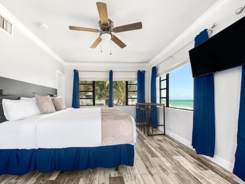 a bedroom with a bed and a ceiling fan at Neptune Oceanfront Rentals in Hollywood