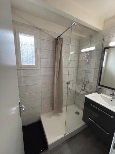 a bathroom with a shower with a glass door at Maison avec plage à pied in Saint-Georges-dʼOléron