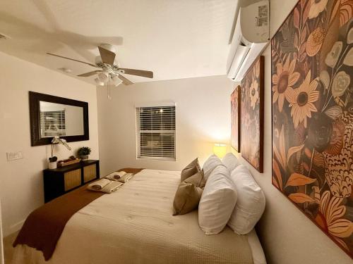 a bedroom with a large bed with white pillows at Golden Sol Casita in Tempe