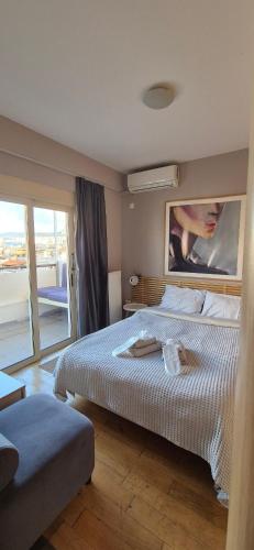 a bedroom with a large bed and a large window at "AcroPool" Penthouse with Private Pool & Acropolis View in Athens