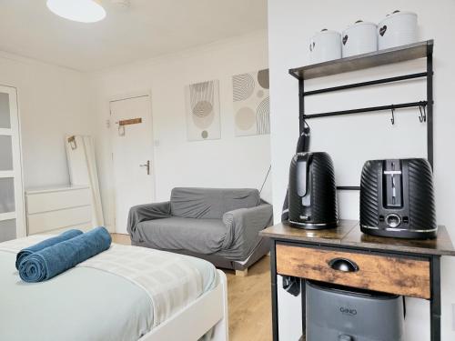 a bedroom with a bed and a television on a table at Studios & Ensuite Doubles - Central RG1 - Oracle - Station & Hospital in Reading