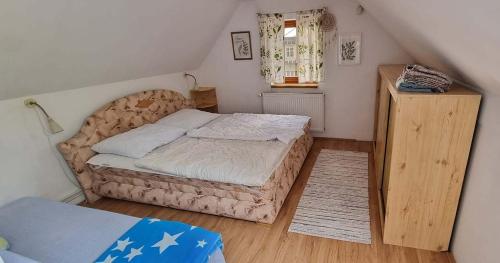 a small bedroom with a bed and a window at Chalupa Špičák in Jablonec nad Nisou