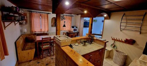 a kitchen with a counter and a table in it at Chalupa Špičák in Jablonec nad Nisou