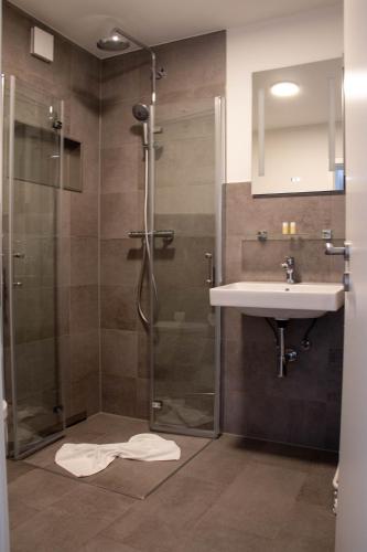 a bathroom with a shower and a sink at Apartments-Altenahr in Altenahr
