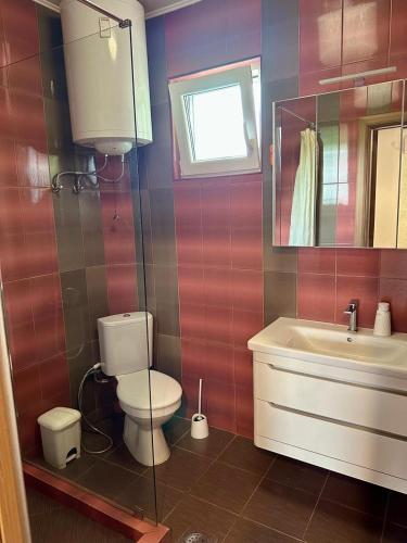 a bathroom with a toilet and a sink at Loft Studio in Igalo