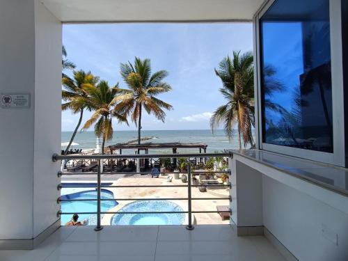 a view of the beach from the balcony of a resort at Hotel Portoalegre in Coveñas